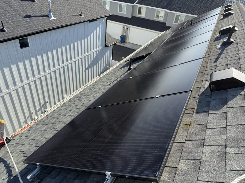 Solar panels on roof from above showing shingle and racking detail
