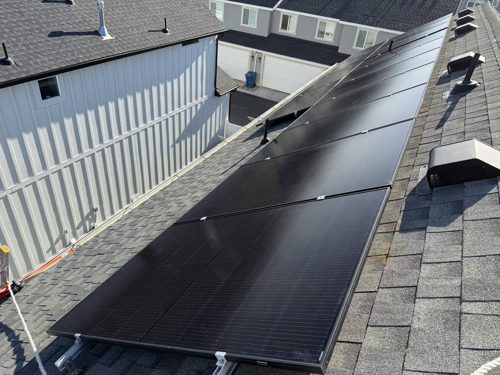 Solar panels on roof from above showing shingle and racking detail