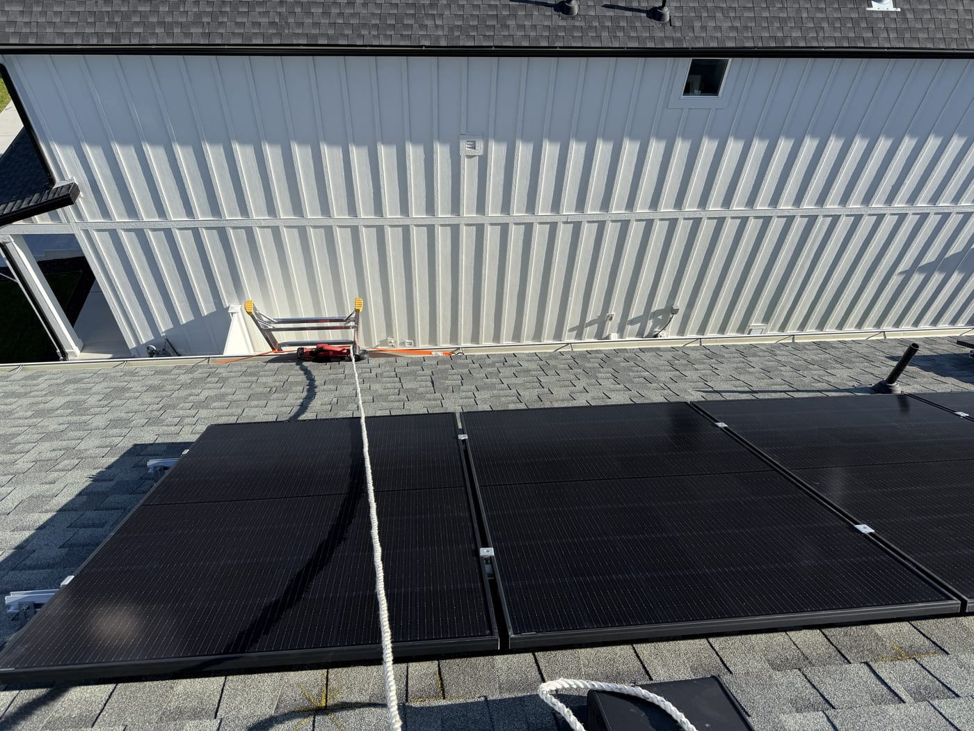 Solar array on shingle roof with metal roof section adjacent