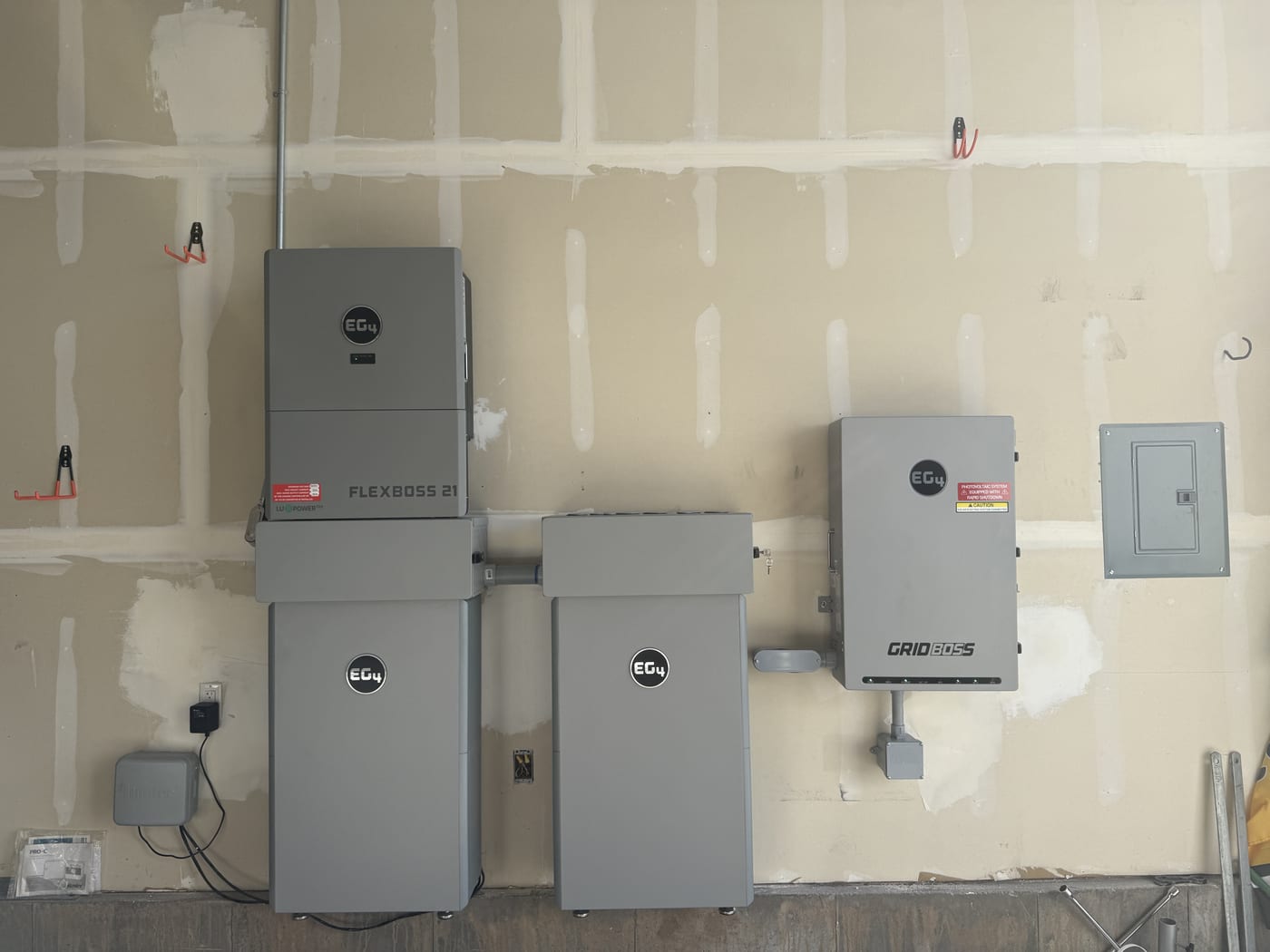 Wide view of EG4 GridBOSS, FlexBOSS 21, and battery units with electrical panel
