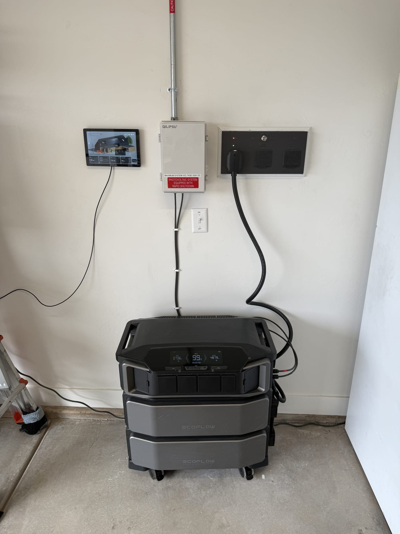 Wide view of EcoFlow DPU battery system with SHP2 units and monitoring tablet on garage wall