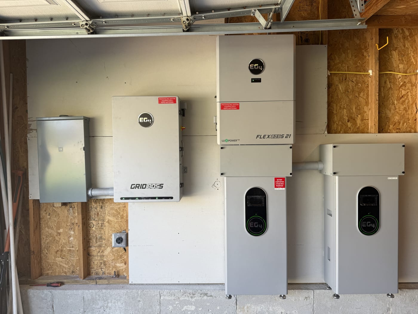Complete EG4 system with GridBOSS inverter FlexBOSS 21 battery and two additional batteries showing green charge displays