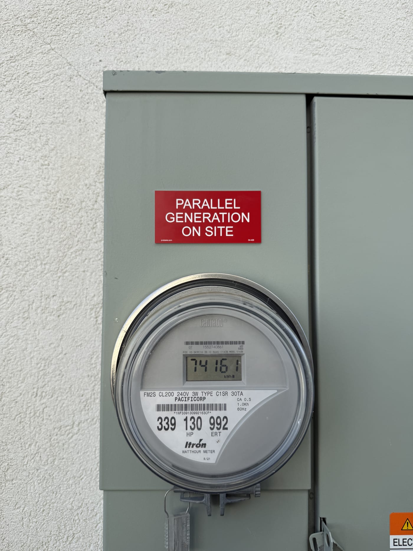 Close-up of electric meter with Parallel Generation On Site label
