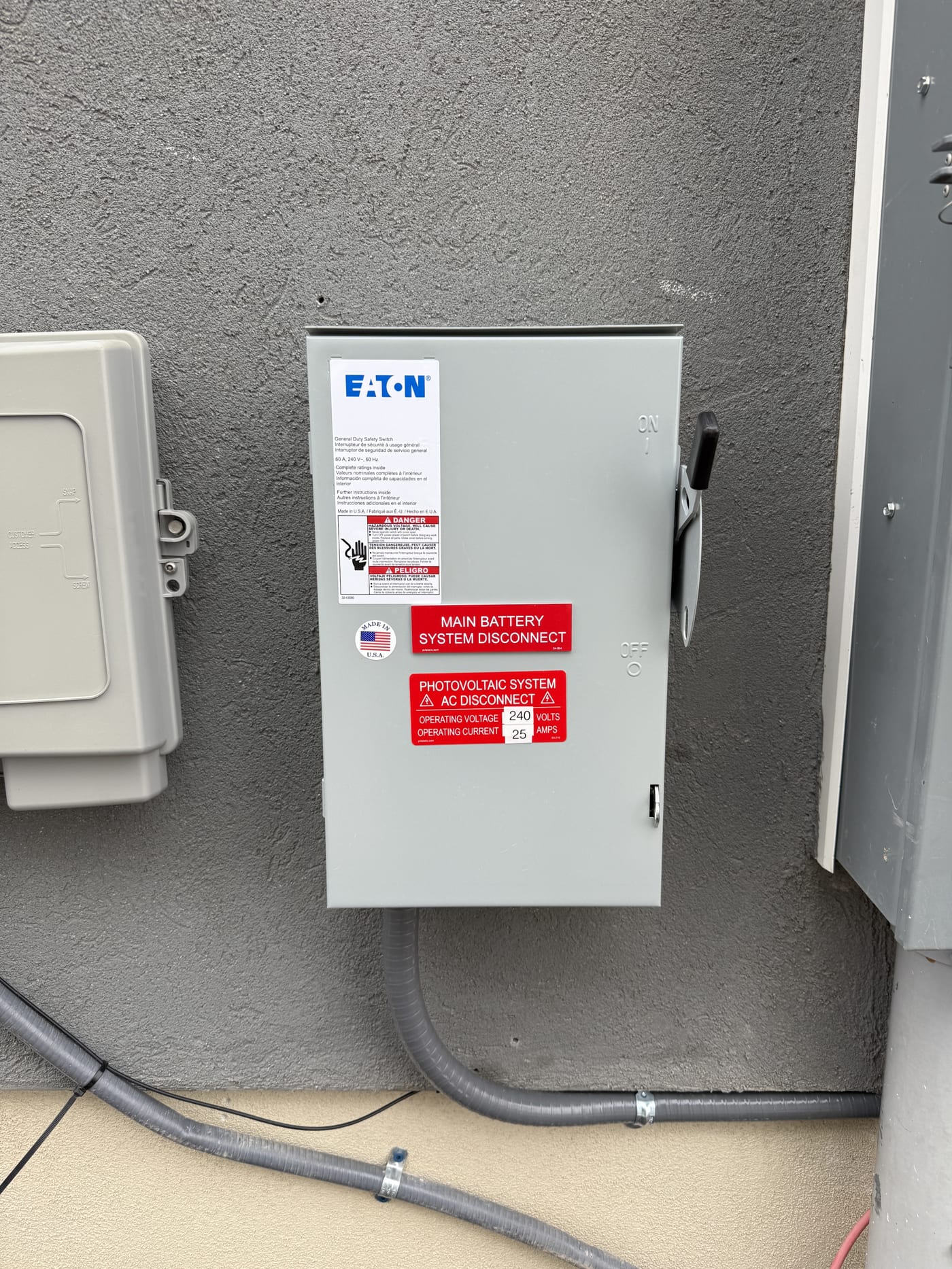 Eaton main battery system disconnect with conduit on exterior stucco wall